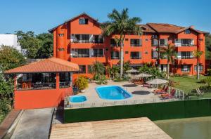 an apartment complex with a swimming pool and a building at Rizzu Marina Hotel in Balneário Camboriú