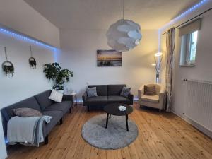 a living room with a couch and a table at Ferienwohnung am Kreisel in Duderstadt