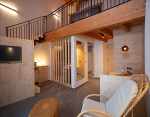 a large living room with a staircase and a tv at Residence Lavina in Caldaro