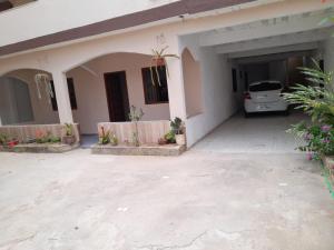 a car parked in the garage of a house at casa de praia in Guarapari +4 photos
