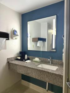 a bathroom with a sink and a large mirror at Baymont by Wyndham Grenada in Grenada +8 photos