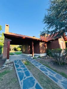 a brick house with a walkway in front of it at Merlinda in Merlo