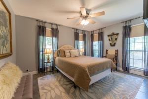 a bedroom with a bed and a ceiling fan at Sleepy Lagoon Cottage in Covington