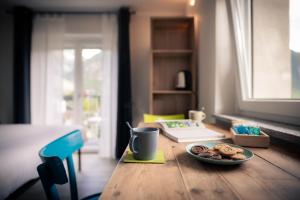 une table avec une assiette de biscuits et une tasse dans l'établissement l'Oura B&B, à Challand Saint Anselme