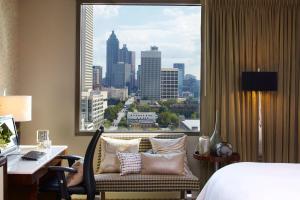 a hotel room with a bed and a desk and a window at Renaissance Atlanta Midtown Hotel in Atlanta +84 photos