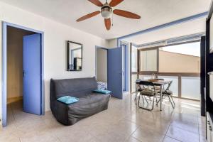 a living room with a couch and a table at SP350-188 Appartement 2 pièces cabine SAINT PIERRE LA MER in Saint Pierre La Mer +7 photos