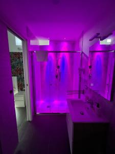 a purple bathroom with a sink and a mirror at Villa Delle Rose in Naples