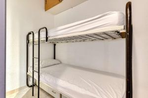 a couple of bunk beds in a room at SP350-188 Appartement 2 pièces cabine SAINT PIERRE LA MER in Saint Pierre La Mer
