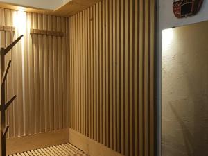 a room with a wooden paneled wall and a door at Résidence Pierre Blanche - Très agréable deux pièces cabine idéalement situé en centre station au pied des remontées mécaniques MAE-7744 in Arc 1600