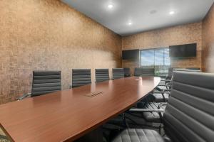 a conference room with a wooden table and chairs at Cobblestone Hotel & Suites - Lynden in Lynden +91 photos