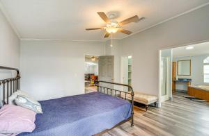 a bedroom with a bed and a ceiling fan at Charming Farmhouse in Morriston with Fenced Yard in Morriston