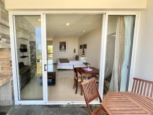 a room with a bedroom and a bed and a table at Zen Boutique Apart Hotel in La Paloma