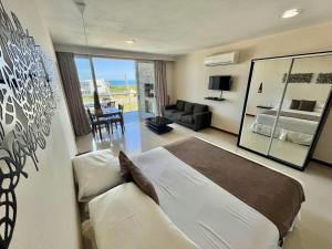 a bedroom with a bed and a living room at Zen Boutique Apart Hotel in La Paloma