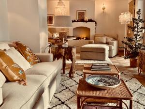 a living room with a couch and a table at SEIN Boutique Suites - ADULTS ONLY in Gosau
