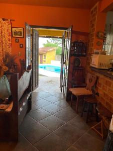 an open door to a kitchen with a pool at Chácara Santa Fe in Ibiúna +6 photos