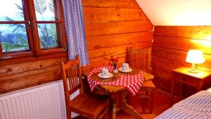 a small table and chairs in a room with a table and a bed at Sonnleiten Zimmer 1 in Abtenau