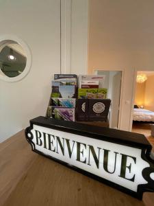 a pile of books sitting on top of a table at La maison d'Aurore et Patrice - jacuzzi couvert et jardin privés in Élincourt-Sainte-Marguerite