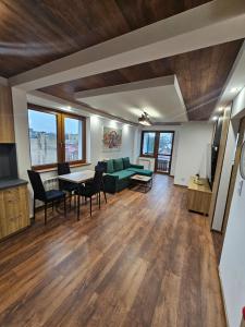 a living room with a green couch and a table at LUXURY GREEN APARTMENT by Marta in Radom