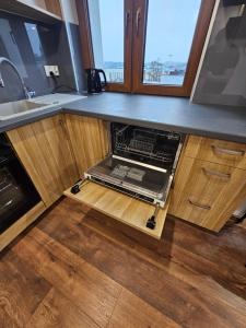an open oven in the middle of a kitchen at LUXURY GREEN APARTMENT by Marta in Radom