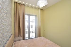a bedroom with a bed and a large window at Very beauty new apartment for good guests in Arabkir