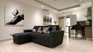 a living room with a couch and a kitchen at Espero Ostia in Lido di Ostia