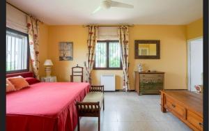 a bedroom with a bed and a dresser and windows at Casa de campo con piscina junto a Sevilla in Mairena del Alcor +48 photos