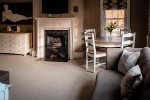 a living room with a fireplace and a table at Gallows Hill in Scarborough