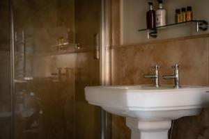 a bathroom with a white sink and a shower at Gallows Hill in Scarborough