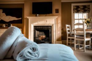 a bed in a room with a fireplace at Gallows Hill in Scarborough