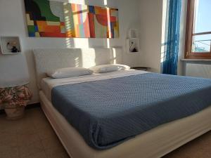 a bedroom with a bed with a blue comforter at Residenza 1898 in Rocca di Papa
