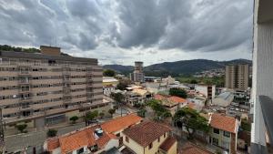 a view of a city with buildings and clouds at Flat Moderno c Nespresso, Alexa e Internet 600Gb in São Lourenço