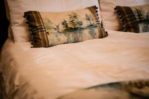 a bed with white sheets and pillows on it at Gallows Hill in Scarborough