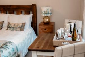 a bedroom with a bed and a table with wine glasses at Gallows Hill in Scarborough