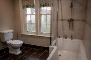 a bathroom with a toilet and a shower and a tub at Gallows Hill in Scarborough +37 photos