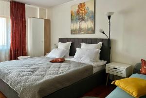 a bedroom with a large bed with white pillows at Casuta cu amintiri in Cîmpulung