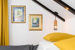 a bedroom with two framed pictures on the wall at Liko Diko Holiday Home in Gospić +22 photos
