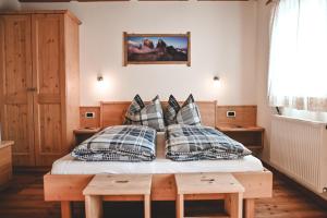 a bedroom with a bed with pillows on it at Kerschbaumhof in San Candido