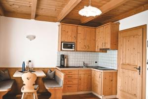 a kitchen with wooden cabinets and a counter top at Kerschbaumhof in San Candido