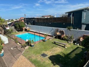 a backyard with a swimming pool and a ship at Seal Point Apartments in Cape St Francis