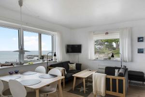 a living room with a table and a couch at Holiday Apartment On The Bornholm Cliffs in Allinge