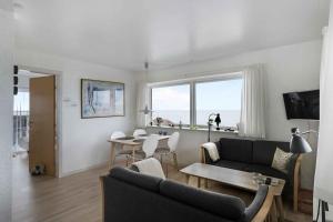 a living room with a couch and a table at Holiday Apartment On The Bornholm Cliffs in Allinge +16 photos