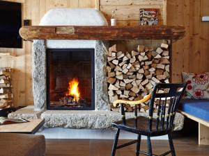 a fireplace with a pile of fire wood at SportLodge RACING SUITE - AlpenLuxus Collection in Kleinboden