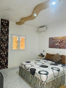 a bedroom with a large bed in a room at Grace house jacuzzi in Saly Portudal