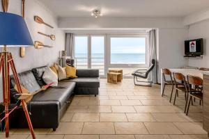 a living room with a couch and a table at Sun Beach 0201 in Sint-Idesbald