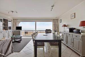a kitchen and dining room with a table and a view at Ensis 0201 P in Sint-Idesbald
