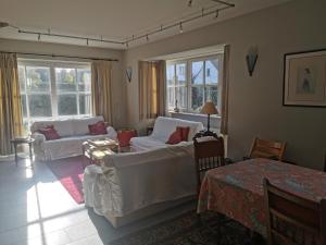 a living room with two couches and a table at Vlierhof in Sint-Idesbald