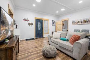 a living room with a couch and a tv at Creekside Cabin - Beaver Lake Creek Access in Rogers