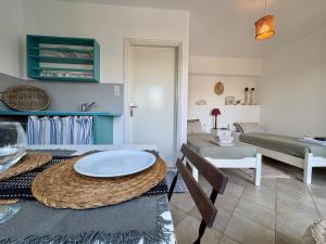 a living room with a table and a couch at Armeos Blue in Myrties