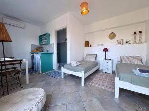 a living room with two beds and a table at Armeos Blue in Myrties