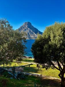 a view of the ocean with a mountain in the background at Armeos Blue in Myrties